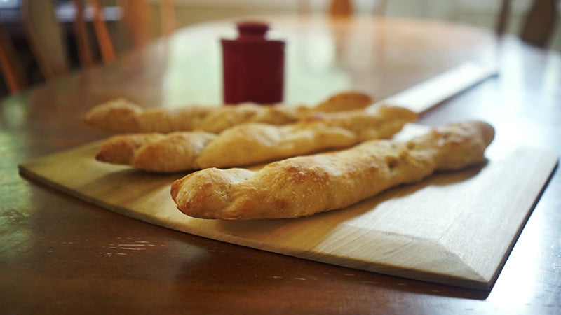 wooden pizza peel with French bread