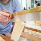 Woman cutting a mortise and tenon joint using a dovetail saw at a hand tool woodworking class