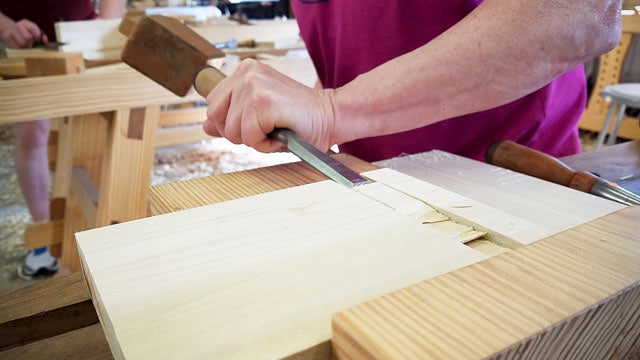 Students making a dado joint with a chisel and joiner mallet at the introduction to hand tool woodworking class