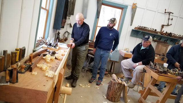 Bill Anderson students how to use a jointer hand plane in a woodworking class