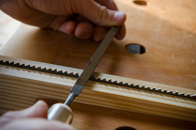 Sharpening a hand saw in a woodworking class