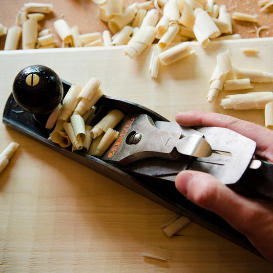 Stanley hand plane with shavings on a board