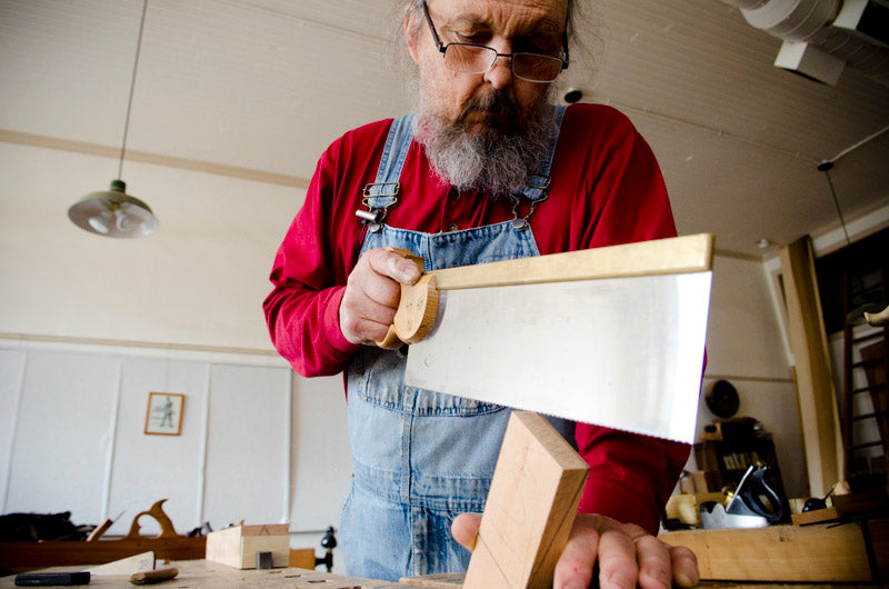 Bill Anderson using a tenon saw to cut a wooden wedge for a wooden hand plane