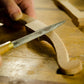 Bill Anderson using a rasp to shape the handle of a Howarth Bowsaw