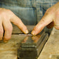 Bill Anderson sharpening and honing a hand plane blade on an oil sharpening stone
