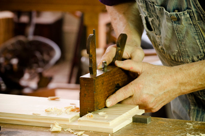 Bill Anderson cutting a dado with a wooden dado plane