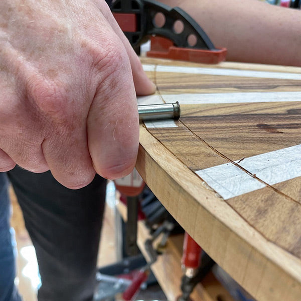Dave Heller using a marking gauge on veneer table top