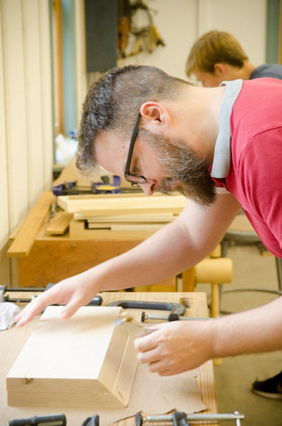 Woodworker in a hand tool woodworking calss making a donkey's ear shooting board