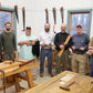 Student with students in a hand plane skills woodworking class