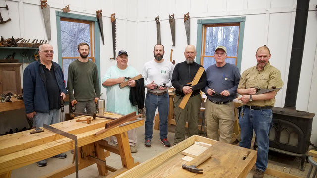 Student with students in a hand plane skills woodworking class