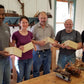 Students at the introduction to hand tool woodworking class holding a dovetail joint