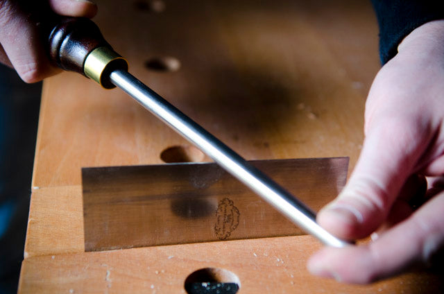 Sharpening a card scraper in a woodworking class