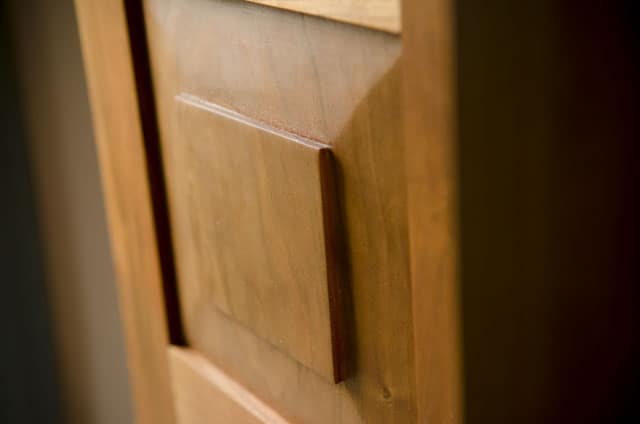raised panel door of a Cherry shaker wall cupboard