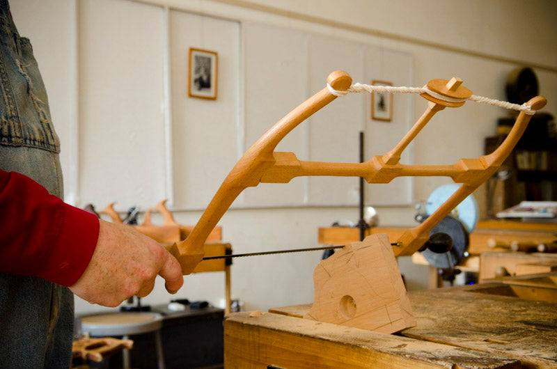 Bill Anderson using a bow saw to cut a handle for a wooden hand plane