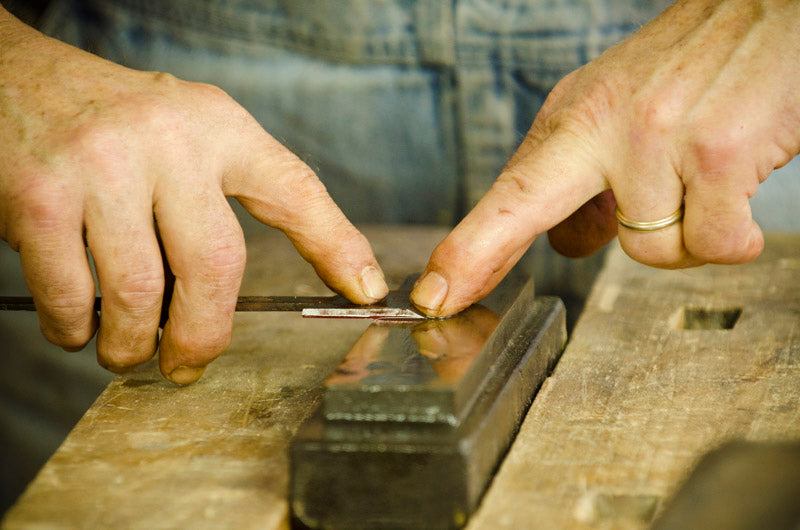 Bill Anderson sharpening and honing a hand plane blade on an oil sharpening stone