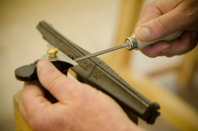 Sharpening hand saw teeth in a hand tool woodworking class 