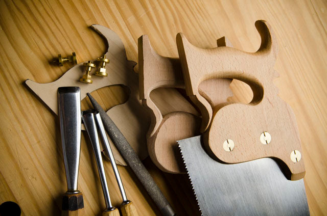 Stages of making a hand saw or panel saw with saw parts, gouges, and a rasp