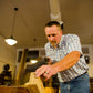 Will Myers using a  woodworking hand saw to cut the legs of a Moravian workbench