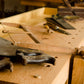 Row of woodworking hand tools on a Moravian workbench