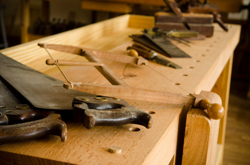 Row of woodworking hand tools on a Moravian workbench