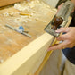 Man using a Stanley jointer plane to joint a board at a hand tool woodworking class