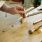 Student in a hand tool woodworking calss using a chisel and mallet to make a wooden try square