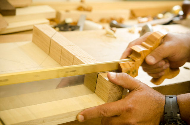 Carcass back saw cutting a kerf in a bench hook in a hand tool woodworking class