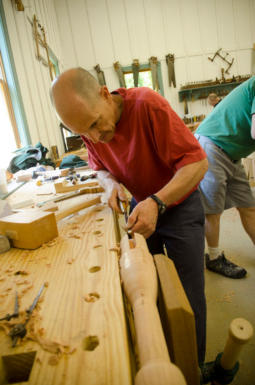 A Male Woodworking Student Using A Chisel To Cut A Sliding Dovetail Joint On A Table Spindle At His Workbench At Joshua Farnsworth'S Wood And Shop Traditional Woodworking School