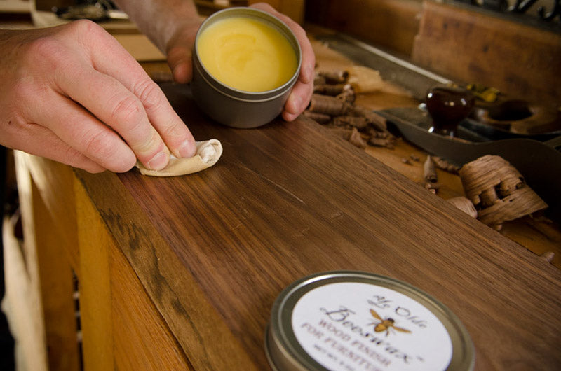 Wiping Beeswax beeswax furniture polish on a walnut board